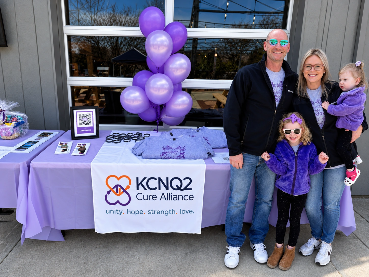 A KCNQ2 family smiling together at a fundraising event